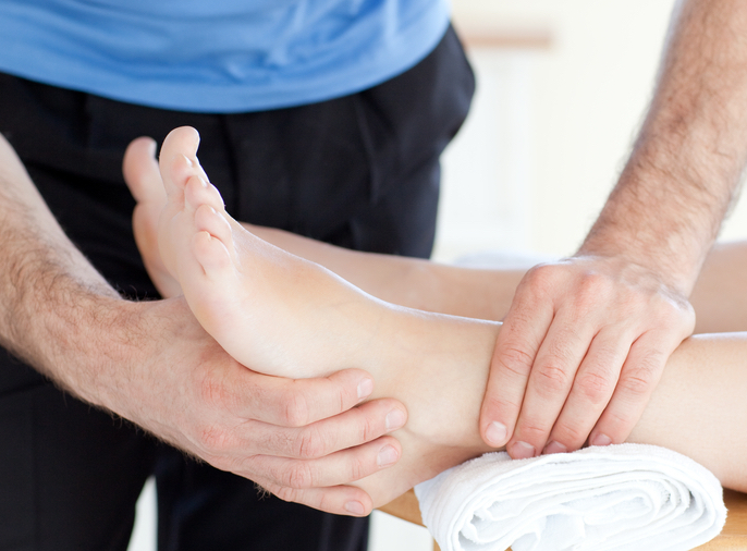 Young woman enjoying a foot massage in Body Works Physio